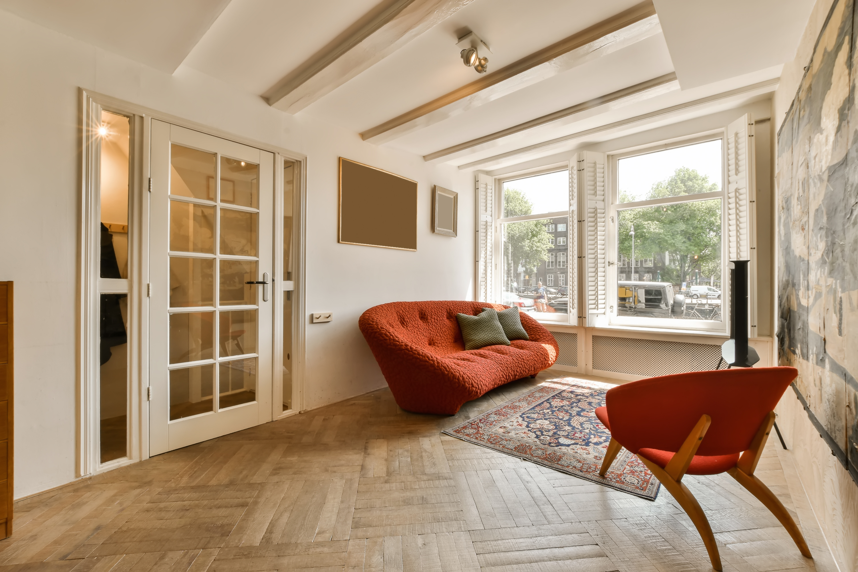 living room with red furniture and a basketweave floor